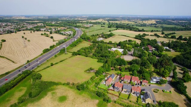 Aerial shot flying over English countryside with busy motorway