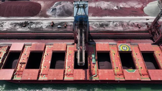 Bulk Carrier Ship Offloading Cargo By Crane for Processing