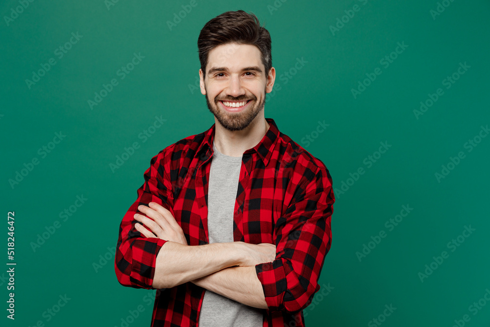 Poster Young happy smiling confident cheerful fun caucasian man he 20s wear red shirt grey t-shirt hold hands crossed folded isolated on plain dark green background studio portrait People lifestyle concept.