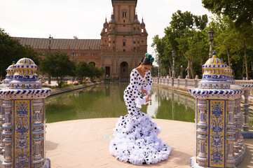Flamenco dancer woman, beautiful brunette teenager dressed in typical costume with ruffles and...