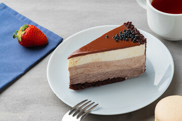Three chocolate cake slice on white plate