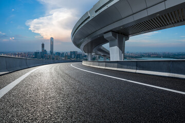 Asphalt road and bridge buildings with city skyline scenery in Suzhou, China.