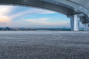 Asphalt road ground and city skyline with bridge building in Suzhou, China.