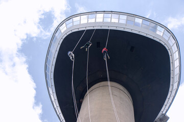 Three young People abseiling down the Eromast tower in Rotterdam - 518251273