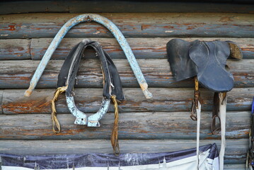 An old yoke for harnessing of draft horses used on a farm. Accessories of an old stable.