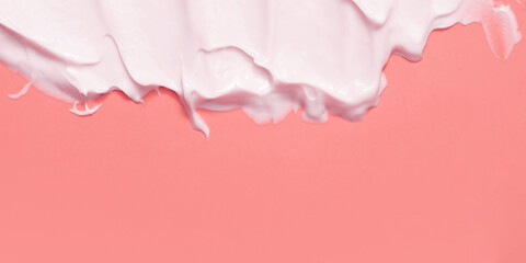 Close-up cream moisturiser smear smudge wavy texture on colored background with copy space horizontal format. Skin care beauty product