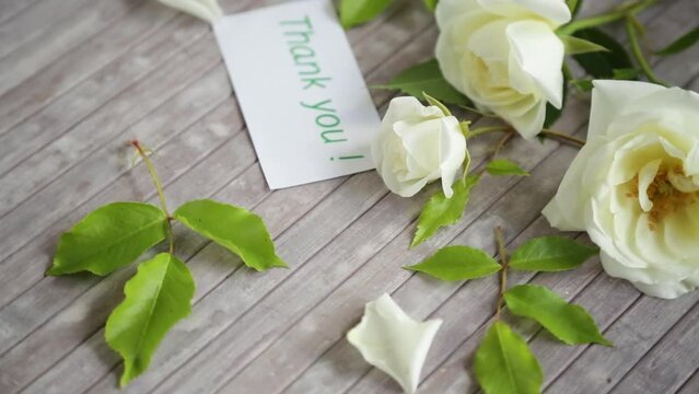 small bouquet of beautiful white summer roses, on a wooden table
