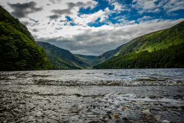 Fototapeta na wymiar The upper lake in Glendalough. this body of freshwater is in a glacial valley in Co. Wicklow Ireland not far from Dublin and is a popular beauty spot enjoyed by tourists hiking walking sightseeing 