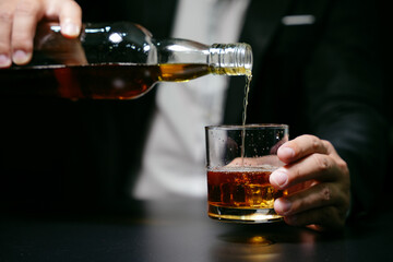 Businessmen in suits drinking whiskey