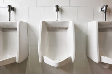 Modern restroom interior with urinal row for men