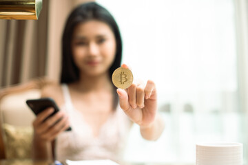 Young 20s Asian Sexy woman wear white lace lingeries show bitcoin etc cryptocurrency in digital...