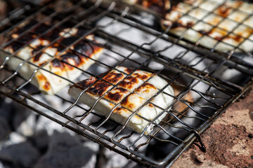 Halloumi cooking on a barbeque, with a shallow depth of field