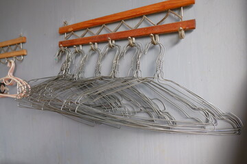 Many metal hangers on a rod. Store concept, sale, design, empty hangers.