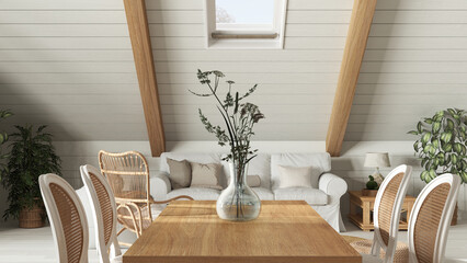 Bohemian dining table close up, living room in boho style with sofa in oak wooden mezzanine with gabled ceiling. Potted plants and decors. Country interior design