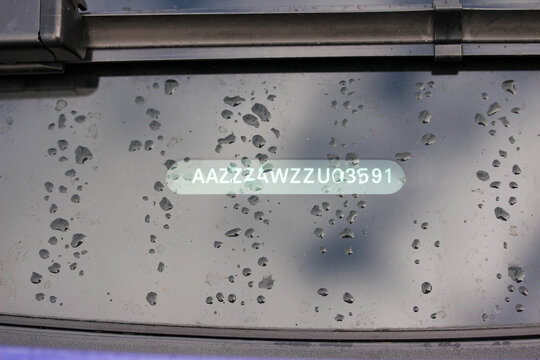 VIN plate under a wet car windscreen
