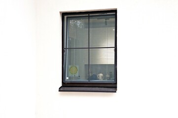 A window in the house. On the window the inscription -Guarded by the police- -Alarm system installed-