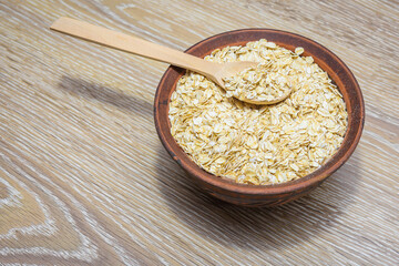 Dry oatmeal in a bowl. Oatmeal is a delicious healthy diet food.