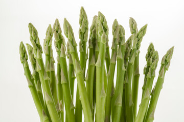 Isolated bunch of fresh asparagus. side view.