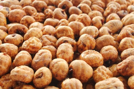 Close-up of chufa, tigernut, earth ground Almond, groundnut, tiger nut, zulu nut, sweet root, tuberous grass, wintergrass, succulent food. Nut for drink horchata, table oil, natural soap. Health idea