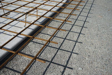 Reinforced concrete road construction and the process of placing the steel grating to prevent cracks (blurred image)