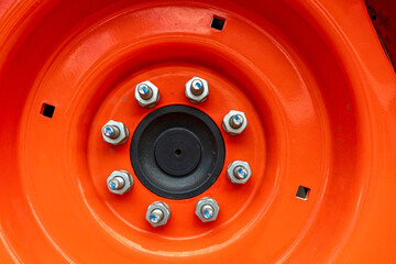 Detail of the bolts on the rim of a tractor wheel © davidrh