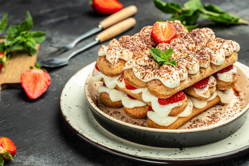 Tiramisu. Homemade tiramisu cake with fresh strawberry, biscuit and whipped cream and mint, Vegan lactose free dessert, Recipe of healthy organic decert