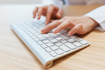 Closeup shot hands of businesswoman journalist office worker freelancer typing report doing documents on keyboard. Online communication, Remote job or Education. Copy space, wide angle