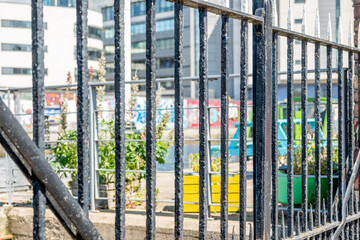 Close and selective focus of metal railings preventing access to private land in the city centre. Intentional bokeh