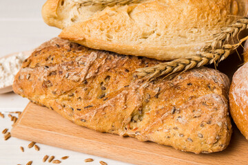 Homemade natural breads. Different kinds of fresh bread as background, perspective view with copy space
