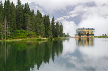 Obraz premium Lake Misurina freshly rained and low clouds on the Tre Cime di Lavaredo peaks is different.