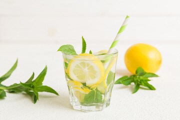 Mojito cocktail. Refreshing mojito cocktail with lime, lemon and mint in a tall glass with a stick