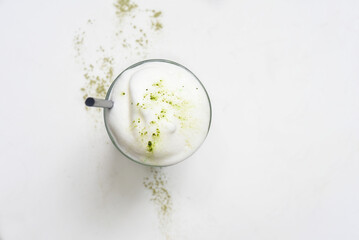 Matcha latte on white background top view