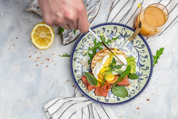 Healthy nutritious paleo keto breakfast diet avocado and Poached Egg, cheese, salmon and fresh salad, fresh juice, Keto breakfast or lunch. place for text, top view