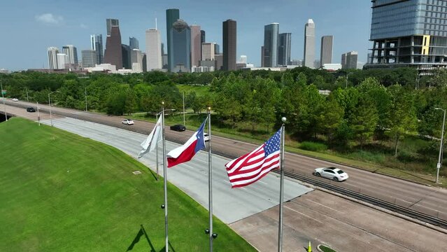 Houston Texas skyline with USA and TX state flag. Skyline aerial pullback reveal shot.