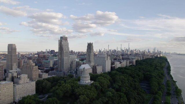 Aerial view around the Riverside church and the shoreline of Upper Manhattan, partly sunny day in NYC, USA