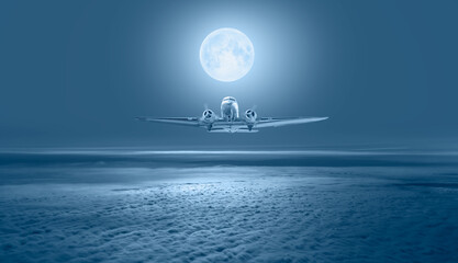 Old metallic propeller airplane in the sky with full moon 