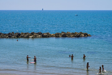 Fototapeta na wymiar Bathers at Anzio beach, Italy 