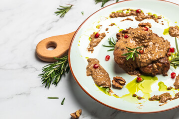 pork medallions with walnut sauce. Georgian cuisine. Ketogenic diet food. Food recipe background. Close up
