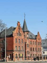 Obraz premium 03.28.2022 Gdansk, Poland. Old European building made of red brick from 19th or 20th century at Juliusza Słowackiego 15. Danzig free city heritage.