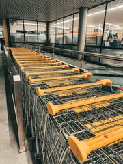 06.21.2022 Gdansk Poland. Close up a line of shopping carts. Handcart in the supermarket name Biedronka. The concept for news header image regarding food prices and shortage. © AlexGo