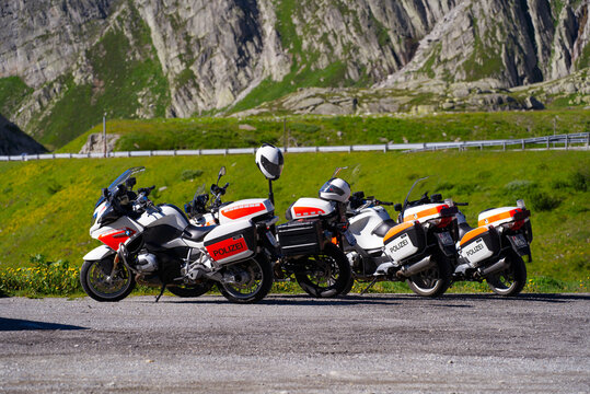 Police motorcycles of cantonal police force of Canton Uri parked at car park at mountain pass St. Gotthard on a sunny summer day. Photo taken June 25th, 2022, Gotthard Pass, Switzerland.