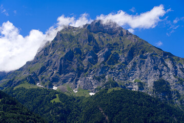 Fototapeta premium Mountain panorama seen from City of Altdorf, Canton Uri, on a sunny summer day. Photo taken June 25th, 2022, Altdorf, Switzerland.