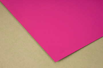 Plain pink n paper sheet lying on brown yellow textured Background like an open book from top angle