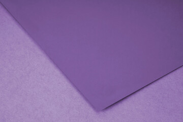 Plain purple paper sheet lying on purple textured Background like an open book from top angle