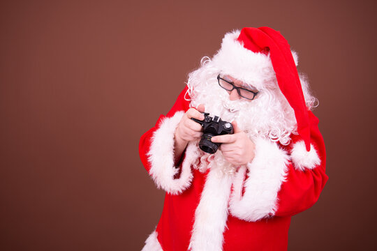 Funny santa claus takes pictures.	