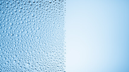 Half of the glass surface is covered with water drops on a blue background | Background for beauty product
