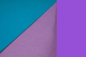 Plain and textured blue pink purple sheet paper arrangement background forming a triangle for creative cover designing