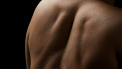 Close-up shot of young good-looking slim African American female model's shoulders on black background | Skin nutrition concept