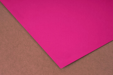 Plain pink paper sheet lying on brown peach red textured Background like an open book from top angle	
