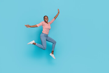 Fototapeta na wymiar Full body photo of overjoyed cheerful lady jump have fun good mood isolated on blue color background